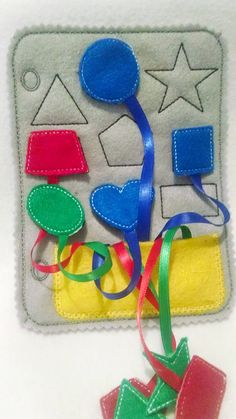 an applique is shown with ribbons and shapes on the back of this item