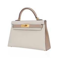 Guaranteed authentic Hermes Kelly HSS 20 Sellier bag featured in coveted Craie and Trench.A stunning neutral color combination for year round wear. Epsom leather accentuated with Gold hardware.Comes with signature Hermes box, shoulder strap, and sleeper.Please visit our Kelly 20 Collection to see our large selection available for you.NEW or NEVER WORN.Unparalleled in trust, integrity and service, mightychic offers a beautiful selection of Hermes at your fingertips.final sale BAG MEASURES:LENGTH Classic Beige Bag For Everyday Luxury, White Epsom Leather Travel Bag, High-end Epsom Leather Bag For Everyday Luxury, White Epsom Leather Bag With Palladium Hardware, Elegant Epsom Leather Shoulder Bag For Everyday Luxury, Beige Epsom Leather Bag With Gold-tone Hardware, Classic Cream Bag For Everyday Luxury, Cream Top Handle Bag With Palladium Hardware, Luxury Everyday Cream Bag