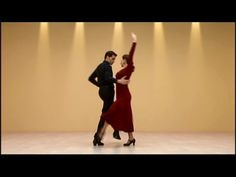 a man and woman are dancing together on the dance floor in front of spotlights