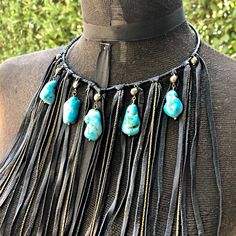 "-This bohemian bib necklace features soft black deerskin leather and turquoise howlite stones, accented by pyrite stones. -A versatile statement piece, this fringe necklace is equally stunning as festival wear, western wear, resort wear, or paired with your little black dress. -The collar is adjustable from 15\" - 17\" with a 2\" adjuster chain in the back. Longer adjuster chain available by request. -Leather fringe hangs 7\" from the collar. -Also available in rust-color leather. -Designed and Bohemian Adjustable Black Turquoise Necklace, Bohemian Black Leather Necklace, Boho Style Bracelets, Diy Leather Earrings, Bison Leather, Handmade Crystal Jewelry, South Pasadena, Black Turquoise, Turquoise Leather