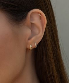 Our viral earring that always sells out. Truly perfect in any piercing location. These unique studs brighten your face and elevate your ears. Safe for sensitive skin, our pieces are hand crafted and made to wear 24/7. Solid 14k gold with 5 natural diamonds (.026 cw). Measures 5mm x 13mm. Available as a single stud or in a pair. If you're unsure which side to order, don't stress —both earrings are nearly identical and work perfectly on either the right or left. These earrings come with our signat Unique Studs, Hair Cuffs, Multiple Piercings, Chain Anklet, Diamond Stud, Diamond Studs, Ring Bracelet, Ear Piercings, Anklets