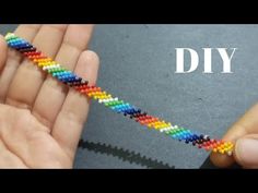 someone is making a rainbow beaded bracelet with their hands and the words diy on it