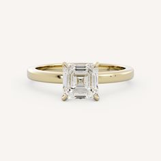 a yellow gold engagement ring with an emerald cut diamond