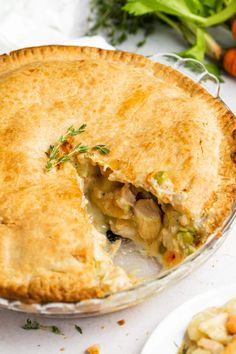 a chicken pot pie is cut in half and ready to be eaten on the table