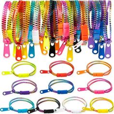 many different colored bracelets and lanyards are lined up on a white background