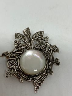 Vintage Pin Marcasite 925 Sterling Silver Brooch Vintage brooch All 925 sterling silver Genuine Marcasite and mother of pearl About an inch All jewelry is shipped free in the US in a nice gift box. Check out our over a THOUSAND great reviews Engraving is $4 per letter and is not always perfect depending on the piece. It can take a few days if the jeweler is busy. This is payable to Paypal Judithsltd@gmail.com Antique White Brooch For Formal Occasions, Elegant Wedding Brooch With Cabochon Detail, Antique White Formal Brooch, Elegant Pendant Brooch With Cabochon, Elegant Sterling Silver Brooch With Cabochon, Victorian White Cabochon Brooches, White Victorian Cabochon Brooches, White Ornate Brooch For Formal Occasions, Victorian White Brooch For Anniversary