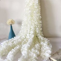 white flowers and blue vases on a table