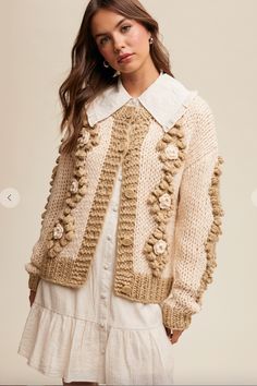 Crochet, flower detailed cardigan. Chic Chunky Knit Sweater For Spring, Spring Cream Knitted Outerwear, Spring Chunky Knit Sweater Coat, Cozy Open Knit Spring Cardigan, Chic Crochet Sweater For Fall, Spring Cozy Open Knit Cardigan, Spring Long Sleeve Crochet Cardigan, Chic Fall Crochet Sweater, Cozy Hand Knitted Sweater Coat For Spring