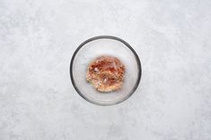 a donut sitting on top of a glass bowl filled with sugar and sprinkles