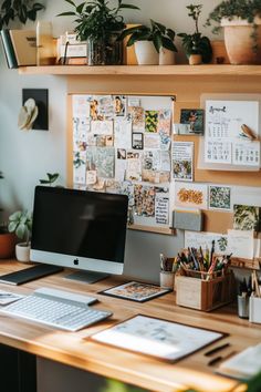 a desk with a computer monitor, keyboard and various office supplies on top of it