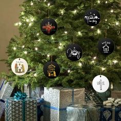 a christmas tree with presents under it and ornaments hanging from the branches on each ornament