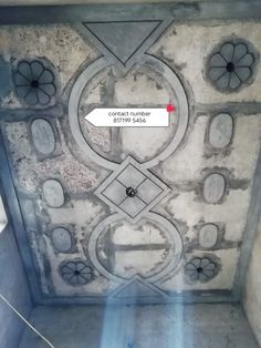 the ceiling is covered in cement and has an arrow pointing to the center with two arrows on it