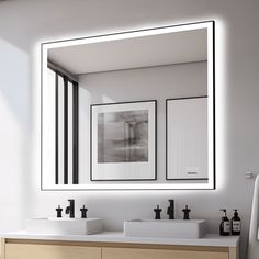 a bathroom with two sinks and a mirror on the wall above it that is lit up