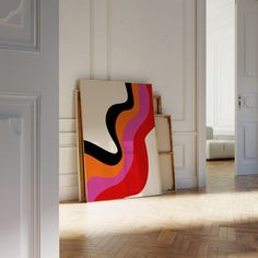 an abstract painting is displayed in the corner of a room with white walls and parquet flooring