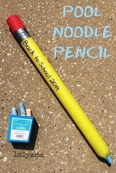 a pencil and eraser sitting on the ground next to a sign that says pool noodle french