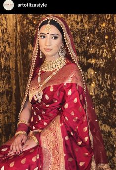 a woman in a red and gold sari