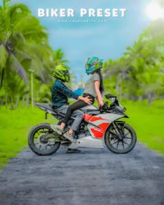 two people riding on the back of a motorcycle down a dirt road with palm trees in the background