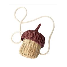 a brown and white wicker bag with a rope on it's shoulder, hanging from the side