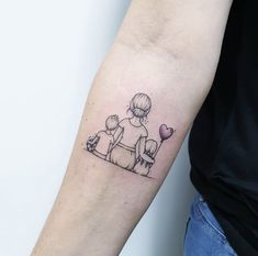 a woman with a small tattoo on her arm holding a balloon and sitting next to a little boy