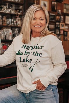 We cannot wait for you to get your hands on this Happier by the Lake ringspun long sleeve! Features a full screen print front and back yoke screen print on an ivory ringspun long sleeve. 100% cotton Relaxed Fit Size Chart Long Sleeve Shirt Outfit, Sleeve Shirt Outfit, Long Sleeve Shirt Outfits, Lake Girl, By The Lake, Camping Shirt, Full Screen, Lifestyle Brands, Screen Print