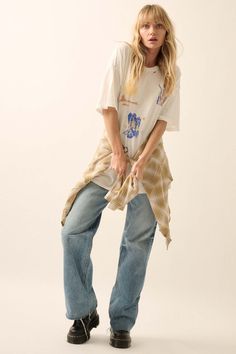 Distressed, garment washed graphic t-shirt. Torn and distressed detailing at neckline, cuffs, and hem. Vintage-style wild west print with desert, cactus, cowboy boot, and cowgirl graphics. Round neckline. Short sleeves. Drop shoulder. Oversized fit. 100% Cotton. Imported top designed and printed in LA. Model wears size S. Casual Pre-washed Tops For Spring, Casual Distressed Tops For Rodeo, Oversized Tops For Rodeo In Spring, Oversized Spring Tops For Rodeo, Oversized Casual T-shirt With Frayed Hem, Casual Acid Wash T-shirt With Frayed Hem, Relaxed Fit Cotton T-shirt With Frayed Hem For Spring, Casual Relaxed Fit Tops For Rodeo, Relaxed Fit T-shirt With Frayed Hem For Fall