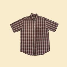 Vintage short sleeve plaid burgundy, brown, and white shirt with a front pocket and a collar, manufactured ca. 1980s by St. Johns Bay. Size M.   - Time Period: c. 1980s  - Brand: St. Johns Bay  - Size: M  - Colors: Burgundy red, brown, white  - Materials: 100% cotton  - Made in: India  - Condition: In good, vintage condition w/ some minor pulled threads/pilling.  Measurements:   - Armpit to armpit: 22.75"  - Shoulder: 18"  - Length: 29.75"  - Sleeve: 10.25" Note: our measurements are taken with Classic Plaid Tops For Casual Gatherings, Classic Brown Unstructured Top, Plaid Relaxed Fit Shirt For Summer, Brown Short Sleeve Shirt With Button Closure For Summer, Relaxed Fit Plaid Shirt For Summer, Summer Plaid Relaxed Fit Shirt, Plaid Relaxed Fit Short Sleeve Button-up Shirt, Relaxed Fit Plaid Short Sleeve Button-up Shirt, Summer Plaid Shirt For Casual Gatherings