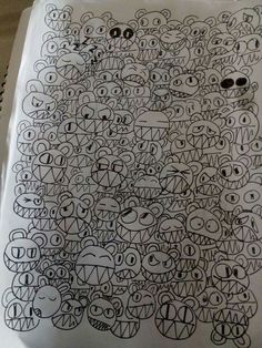 a drawing with many faces and eyes on the side of a sheet of white paper