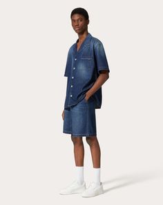 Valentino denim chambray bermuda shorts - Relaxed fit - Two side pockets - Two rear pockets - Elasticated waist - Composition: 100% Cotton - Length: 50 cm / 19.7 in. in an Italian size 46 - Leg opening: 34.5 cm / 13.6 in. in an Italian size 46 - The model is 187 cm / 6'1" tall and wears an Italian size 46 - Made in Italy The look of the model is completed by Valentino Garavani Freedots Shoes. Denim Blue Cargo Shorts, Denim Shorts With Side Pockets, Summer Denim Shorts With Side Pockets, Relaxed Fit Denim Cargo Shorts, Medium Wash Cargo Shorts For Summer, Summer Medium Wash Cargo Shorts, Medium Wash Cotton Shorts With Patch Pockets, Dark Wash Cargo Jean Shorts For Summer, Summer Medium Wash Bottoms With Patch Pockets