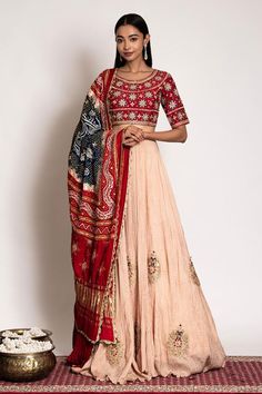 Beige attached can-can lehenga with scattered resham and gota embroidered motifs. Paired with a padded blouse with all over gota hand embroidery and tri-shaded bandhani dupatta.
Components: 3
Pattern: Embroidery
Type Of Work: Resham, Gota
Neckline: Scoop Neck
Sleeve Type: Half Sleeves
Fabric: Pure Georgette, Silk
Color: Beige
Other Details: 
Lehenga:
Attached can-can
Length: 42 inches
Blouse:
Padded
Length: 14 inches
Dupatta:
Gota embroidered highlights
Approx. product weight: 4-5 kgs 
Disclaime Luxury Meenakari Georgette Dupatta, Transitional Chanderi Lehenga With Gota Work, Traditional Raw Silk Lehenga With Gota Work, Festive Raw Silk Lehenga With Gota Work, Festive Raw Silk Choli With Gota Work, Traditional Drape Choli With Gota Work For Reception, Navratri Gota Work Embroidered Fabric For Reception, Red Raw Silk Choli With Mirror Work, Traditional Silk Lehenga With Mirror Work