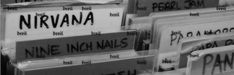 black and white photograph of street signs stacked on top of each other