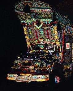 an elaborately decorated truck is parked in the dark