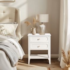 a bedroom with a bed, nightstand and two lamps on the side tables next to each other