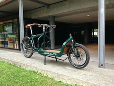 a green bike parked in front of a building