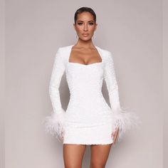 Jade Long Sleeved Sequin Mini Dress W/ Feather Trim- White. Never Worn. Nwt! Elegant White Mini Dress With Feathers, Elegant Mini Dress With Feathers, Formal White Mini Dress With Feather Trim, Elegant Feathered Mini Dress For Cocktail, White Fitted Mini Dress With Feathers, White Long Sleeve Dress With Feather Trim, White Bodycon Dress For Fall Evening, Elegant Cocktail Mini Dress With Feathers, Elegant Mini Dress With Feather Trim For Fall