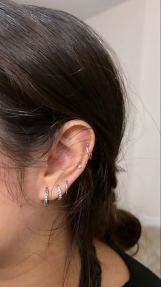 a close up of a person with ear piercings