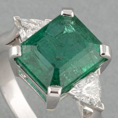 Natural Emerald Cut Emerald Octagon Ring In 14k Gold 2.50Carat Deep Green Genuine Emerald Dainty Ring Wedding Engagement Ring Gift For Women Displayed is a natural untreated deep green 2.35Ct natural emerald cut octagon in Centre with two trillion-cut moissanites to the sides in solid 14k white gold. This classic vintage inspired emerald ring displays beautiful shade of blue and green hue with very good luster and minor flaws that are normal in all natural emeralds. Make it a beautiful wedding or engagement ring for women or a gorgeous ring gift for mother. These are High Quality Untreated Natural Emerald & Moissanites. 𝐒𝐩𝐞𝐜𝐢𝐟𝐢𝐜𝐚𝐭𝐢𝐨𝐧𝐬: 𝐌𝐚𝐭𝐞𝐫𝐢𝐚𝐥 :  ❖ Material : 14k White Gold/925 Silver ❖ Weight : 5 Grams  𝐆𝐞𝐦𝐬𝐭𝐨𝐧𝐞 : Natural Emerald & Moissanite ❖ Gemstone Shap Luxury Emerald-cut Birthstone Ring As A Gift, Gia Certified Platinum Gemstones Fine Jewelry, Gia Certified Trillion Cut Diamond Ring For Formal Events, Gia Certified Trillion Cut Diamond Ring For Formal Occasions, Luxury Gia Certified Emerald Cut Gemstones, Trillion Cut Platinum Gemstone Rings, Trillion Cut Emerald Ring For Formal Occasions, Luxury Three Stone Gemstones For Anniversary, Luxury Trillion Cut Emerald Ring For Formal Occasions