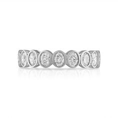 a white gold ring with five round diamonds on the side, set in 18k white gold