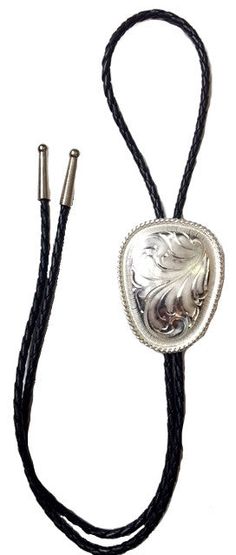 Shop Western Silver Engraved Bolo Tie with engraving on a 36-inch black braided leather cord. Get the best deal with 30 days return policy from Wild West Living. Silver Lariat Bolo Tie With Adjustable Length, Silver Lariat Bolo Ties With Adjustable Length, Vintage Adjustable Bolo Tie For Formal Occasions, Silver Lariat Bolo Tie For Gift, Formal Concho Bolo Ties, Vintage Adjustable Hand Tooled Bolo Tie, Adjustable Vintage Hand Tooled Bolo Tie, Black Western Bolo Tie With Concho, Western Style Black Bolo Tie With Adjustable Length