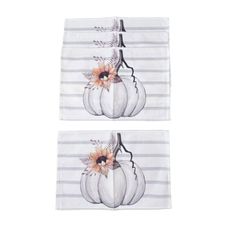 two white pumpkins with flowers on them are sitting next to each other in front of a black and white striped background