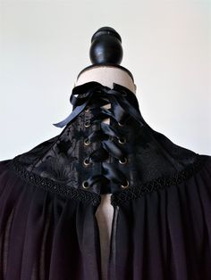 High Neck Black Capelet, Wedding Black Cape, Vampire Costume Victorian capelet made of black brocade and black chiffon fabric. It has back satin lacing and 13 plastic bones. NEW Brocade The brocade od the neck corset is the one of the last photo. -------------------------------------------- SHIPPING Please provide a valid phone number so that the package can be delivered correctly. ------------------------------------------ FOLLOW US Facebook: https://www.facebook.com/haizeaarranz Instagram: @ha Victorian Capelet, Black Capelet, Victorian Cape, Witch Props, Wedding Capelet, Wedding Corset, Neck Corset, Dark Queen, Vampire Costume