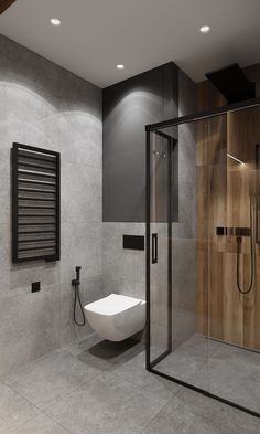 a bathroom with a glass shower stall, toilet and sink in the middle of it