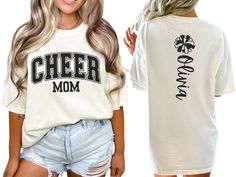 Celebrate your cheerleader with our varsity-style "cheer mom" shirt, featuring bold letters on the front. The back showcases a pom pom and is personalized with your cheerleader's name, making it the perfect gift for any proud cheer mom or mama passionate about cheerleading. COMFORT COLORS 1717 SHIRT: Unisex 100% US cotton - ethically grown and harvested Pre-Shrunk Fabric Relaxed Fit - Size up for a trendy oversized look Seamless Sides Double Needle Stitching Garment-dyed  CARE INSTRUCTIONS: Wash Cheer Mom Era Shirt, Cheer Shirt Ideas Design, Cheer Fan Shirts, Cheer Family Shirts, Senior Cheer Mom Shirts Design, Varsity Fan Gear T-shirt With Lettering, Varsity Style Fan Gear T-shirt With Lettering, Varsity Lettering T-shirt For Fan Gear, Collegiate T-shirt For Cheerleading With Team Name