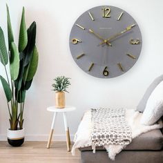 a living room filled with furniture and a large clock on the wall above it's face