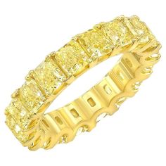 Discover the epitome of luxury with our IGI Certified 18K Yellow Gold Fancy Yellow Cushion Diamond Eternity Band Ring. This breathtaking piece is meticulously crafted from 18-karat yellow gold and showcases a magnificent array of 19 natural, fancy yellow cushion-cut diamonds, perfectly matched and set in a shared prong setting. Exceptional Brilliance: The ring boasts a total carat weight of 5.0 cttw, ensuring a continuous display of radiant sparkle. Each diamond is color-graded as Yellow and boa Exquisite Yellow Jewelry With Brilliant Cut, Luxury Yellow Sapphire Fine Jewelry Ring, Exquisite Yellow Hallmarked Jewelry, Luxury Yellow Citrine Rings, Luxury Yellow Sapphire Ring, Fine Jewelry, Modern Wedding Rings, Cushion Diamond Ring, Yellow Cushion, Fancy Yellow Diamond