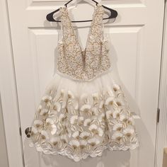 Mac Duggal White And Gold Beaded Dress. Soft U-Shaped Front And Back, Center Back Zipper. Never Worn, Still Has Tags! Stored In Dress Bag. Size: 10, Pit To Pit: 18", Waist: 30" Around, Shoulder To Hem: 35" Smoke Free, Dog Friendly Home. Please Make An Offer! Create A Bundle To Get Further Discounts And Free Shipping! No Reasonable Offer Refused! Embellished V-neck Mini Dress For Wedding, White Embellished Mini Dress For Prom, White Embellished Mini Dress For Wedding, Elegant White Dress With Pearl Embroidery, Elegant Floral Embroidery Dresses For Homecoming, Elegant Floral Embroidery Homecoming Dresses, White V-neck Homecoming Dress, White Pearl Embroidered Cocktail Dress, V-neck Embellished Mini Dress For Wedding