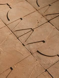 a close up view of the letters and numbers on a cement surface with lines drawn in it