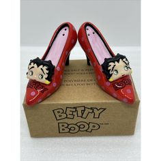 Add Some Flair To Your Kitchen With These Fun And Colorful Betty Boop High Heeled Shoe Salt & Pepper Shakers! Featuring A Cute Pink Polka Dot Design With Betty Boop's Face On The Front, These Ceramic Shakers Are A Must-Have For Any Betty Boop Fan. Perfect For All Occasions, These Shakers Are Great For Adding A Touch Of Personality To Your Dining Table. With A Height Of 2 Inches And A Length Of 4.5 Inches, These Shakers Are A Great Size For Everyday Use. The Set Includes Two Shakers, Each With A Red Lipstick Kisses, Dog Kisses, Hearts And Roses, Face Mug, Polka Dot Design, Dot Design, Pink Polka Dots, Box Color, Iconic Characters