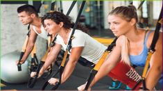 a group of people working out on exercise equipment