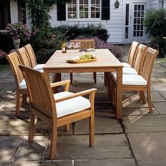 a wooden table and chairs on a patio