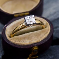 an engagement ring in a wooden box